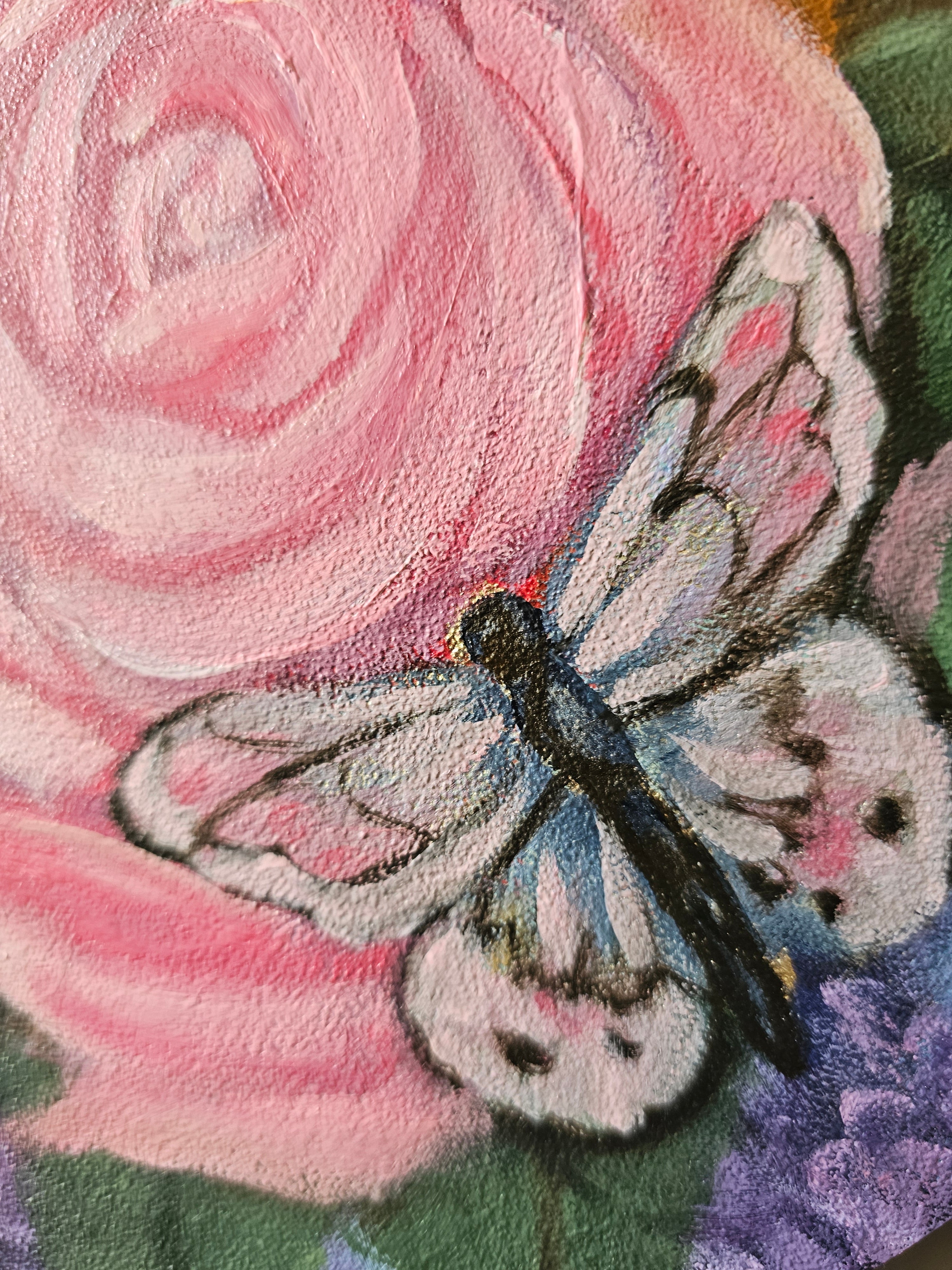 Painted butterfly on a pink rose with a green background