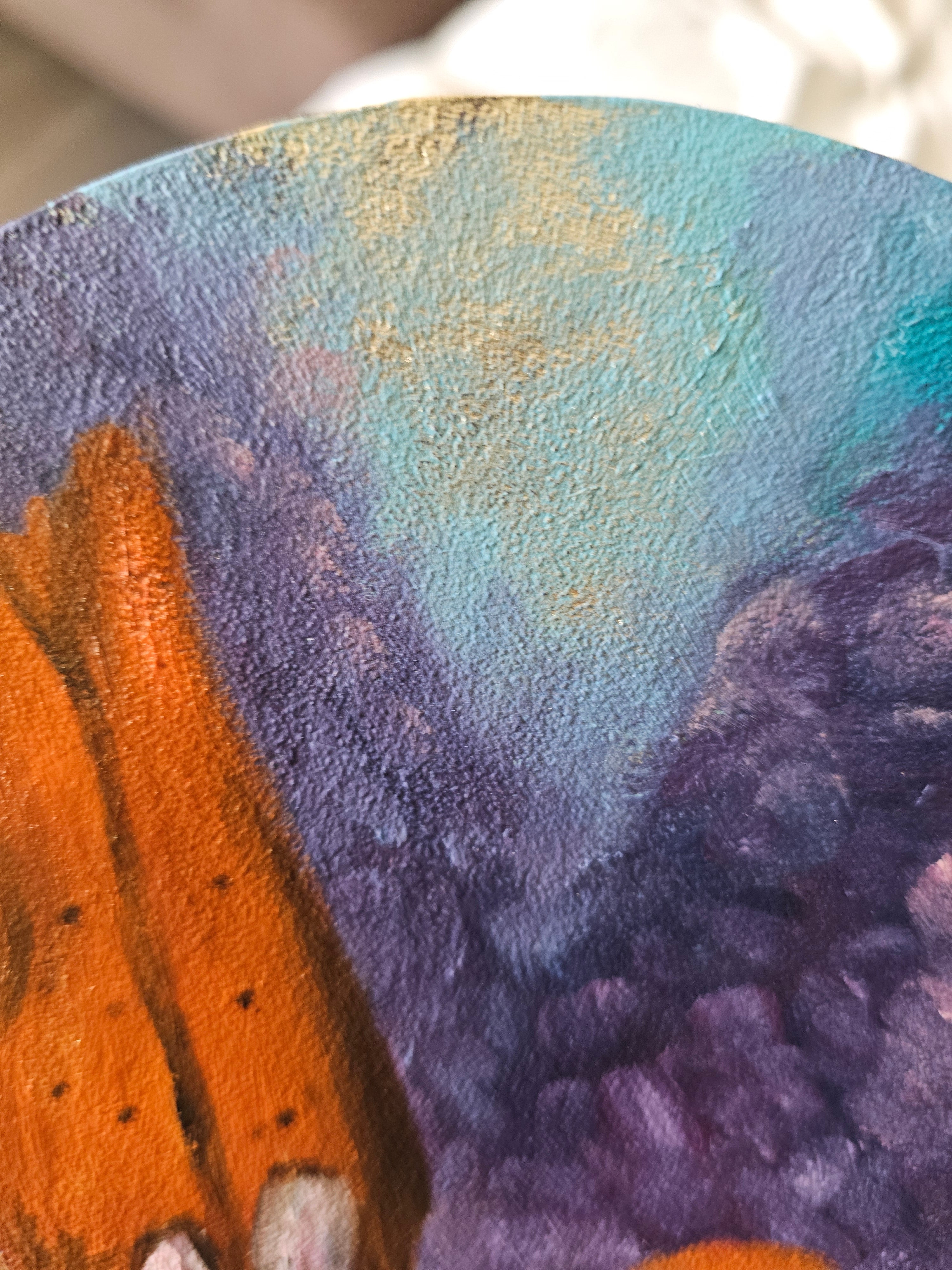 Close-up of painted surface showing gold peeking through.